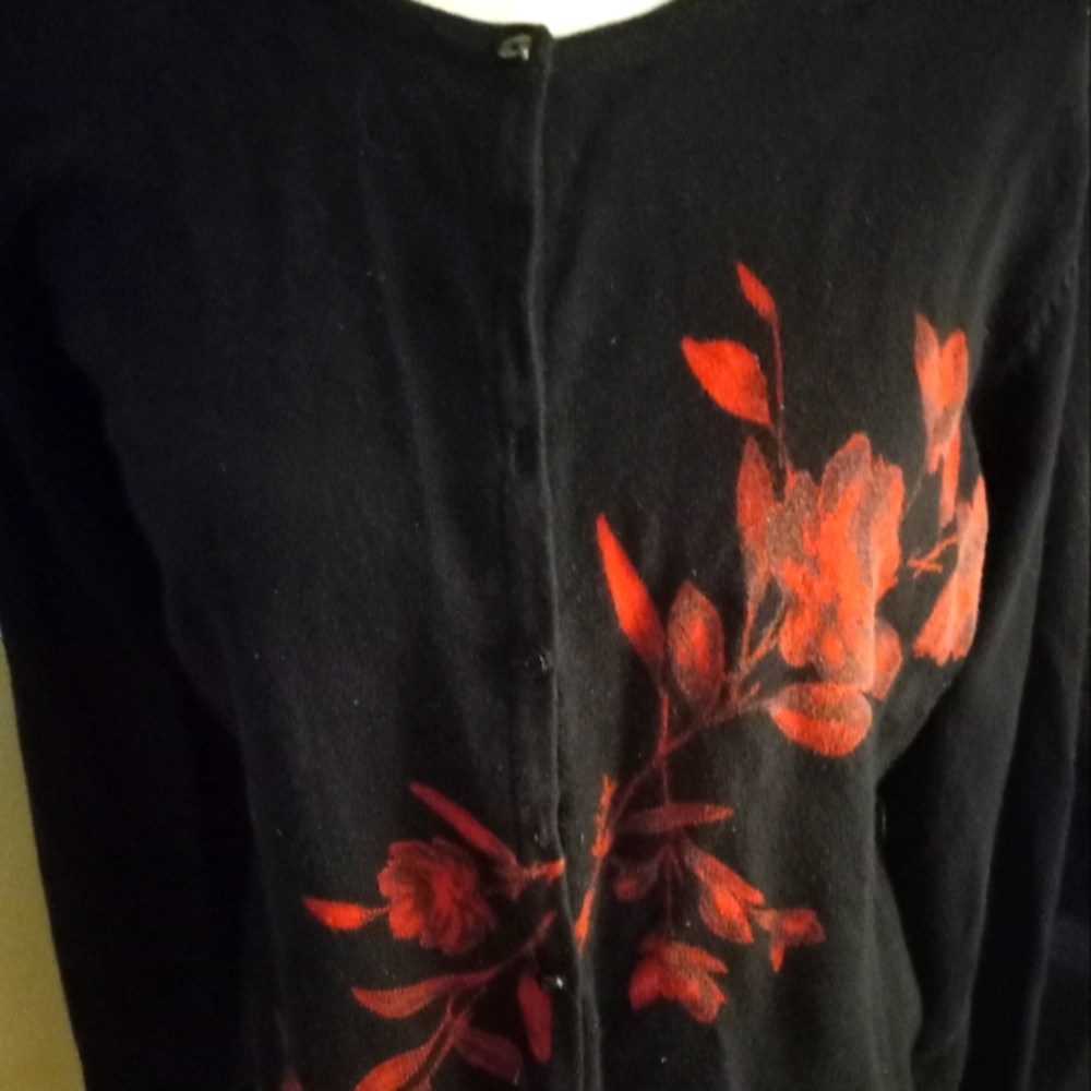 Used not new black with printed red floral pattern on a waist length cardigan.